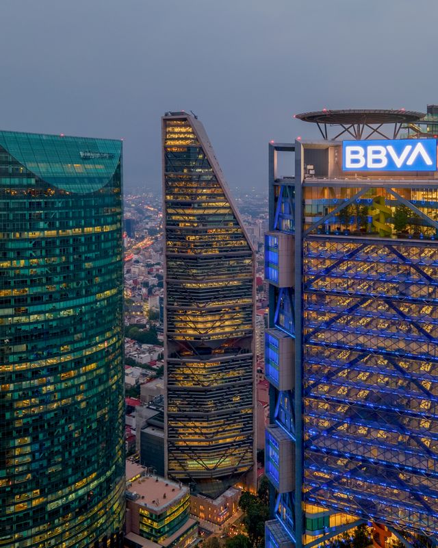 Torre Reforma and BBVA Tower in Mexico City during twilight showcasing modern architecture.